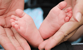 new baby's foot in parent's hand