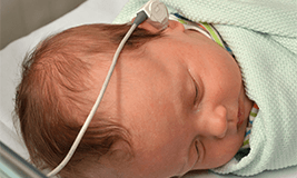 baby with hearing aid picture