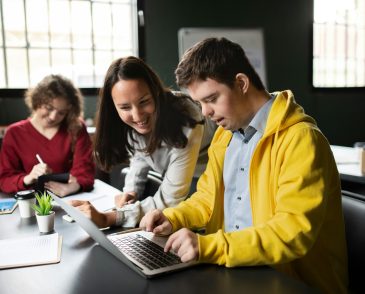 Young man in office using laptop