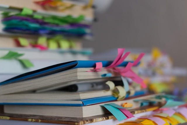 Pile of books with bookmark tags