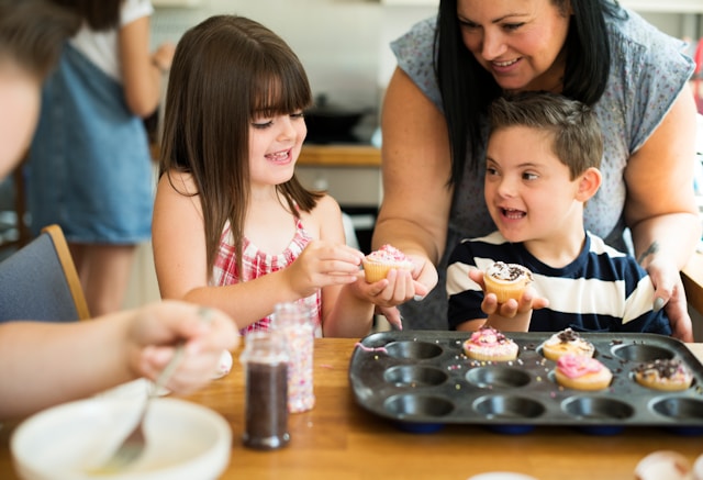 Two children baking with parent
