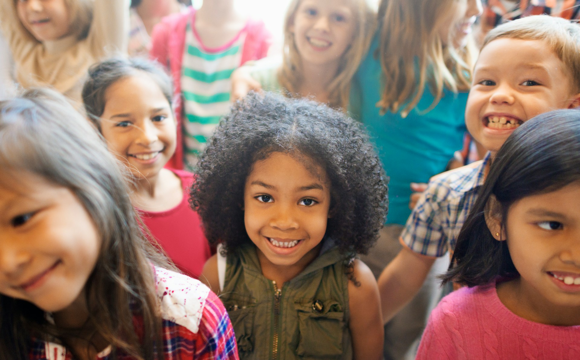 close up of crowd of children smiling